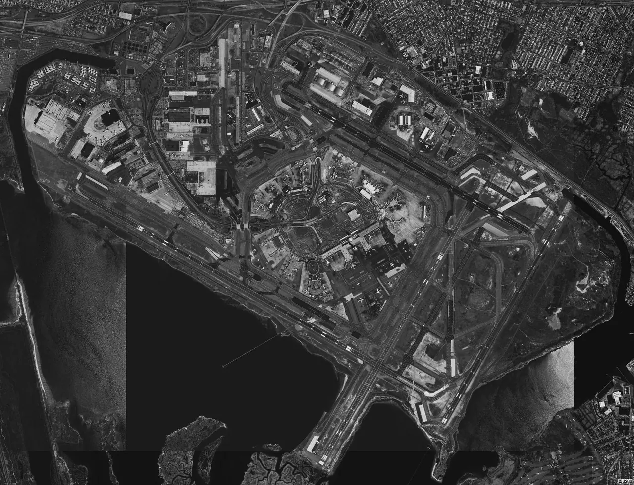 Black and white USGS aerial photograph of John F. Kennedy International Airport from 1994 showing the four runways and the terminal ring
